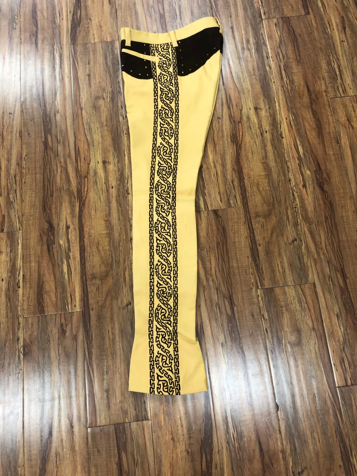 PANTALONES DE CHARRO. AUTHENTIC CHARRO PANTS THAT ARE YELLOW WITH BROWN SUEDE LEATHER STITCHED STENCIL ART WORK 1 PANTALONES DE CHARRO. AUTHENTIC CHARRO PANTS THAT ARE YELLOW WITH BROWN SUEDE LEATHER STITCHED STENCIL ART WORK