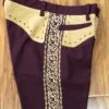 PANTALONES DE CHARRO. AUTHENTIC CHARRO PANTS THAT ARE DARK WINE WITH LIGHT BROWN SUEDE LEATHER STITCHED STENCIL ART WORK